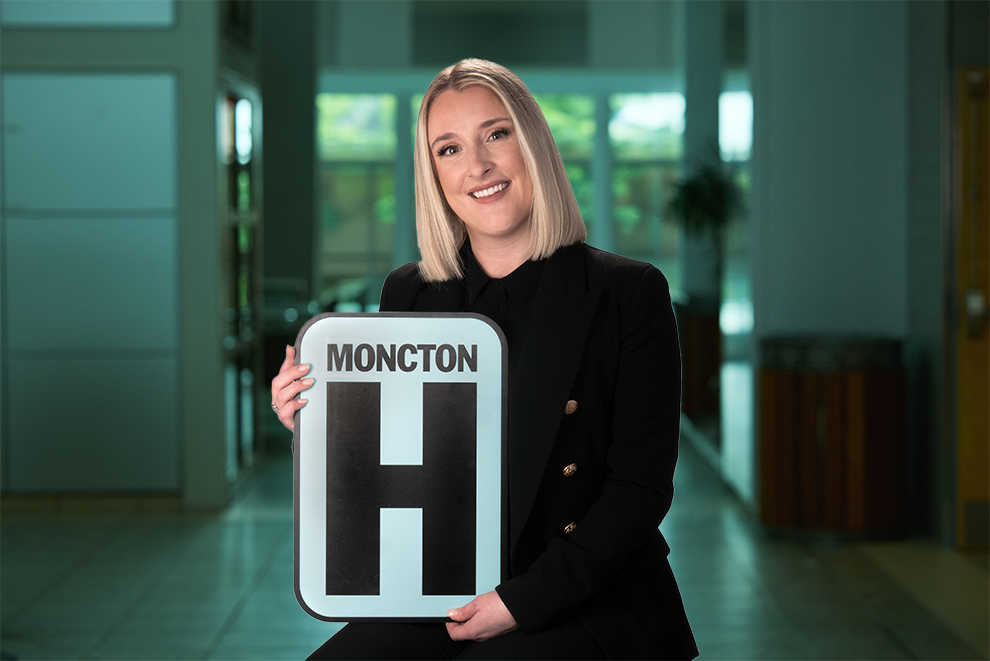 Headshot Holding Moncton H logo
